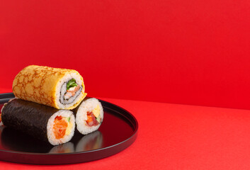 Setsubun, Japanese event. Ehomaki on red background. 節分。赤背景上の恵方巻