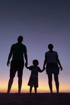 Family at sunset on the beach