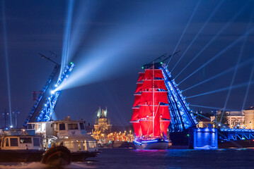 Fototapeta na wymiar A ship with scarlet sails. Floats along the Neva River in the city of St. Petersburg. A celebration dedicated to school graduates.