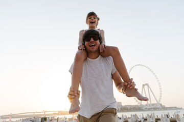 Daughter and father outdoors on the beach