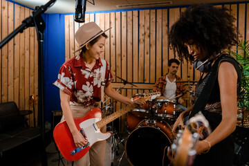 Two young women jamming with their guitars