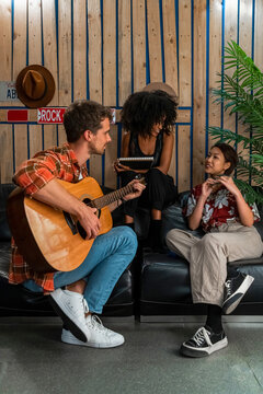 Young musicians producing music in studio