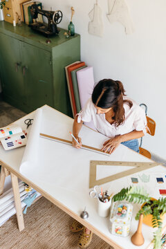 a young dressmaker working on her patterns.