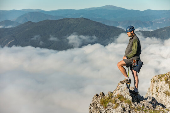 Climber on Top of Cliff 