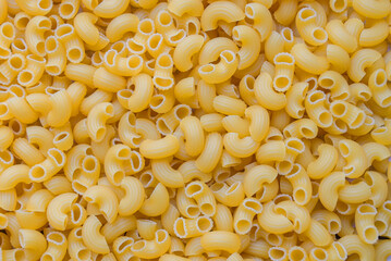 Pasta background - top view, raw macaroni texture background, close up raw macaroni pasta uncooked delicious pasta for cooking food