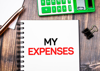 MY EXPENSES - text concept on table with calculator. Financial concept of expenses.