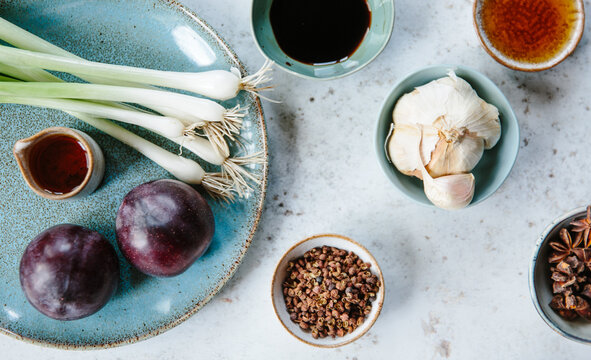 Spring onions, plums and Chinese seasonings.