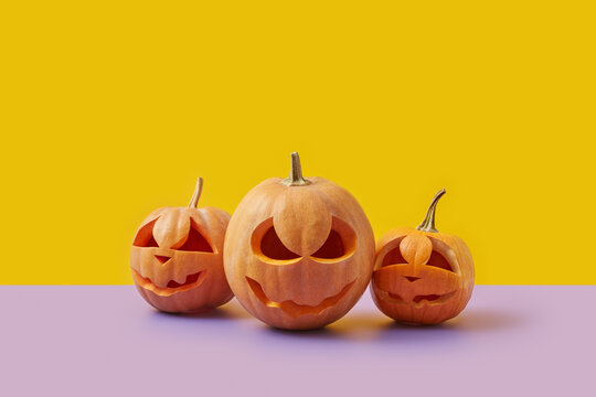 Carved Halloween pumpkins on duotone background.