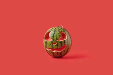 Watermelon with carved smiley face for Halloween.