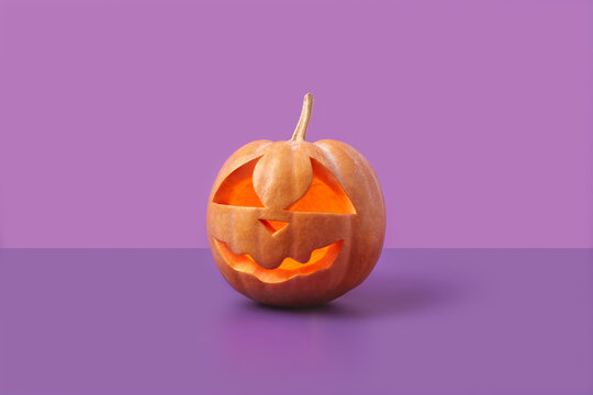 Glowing pumpkin on duotone purple background.