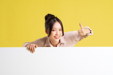 image of asian girl standing and posing with billboard