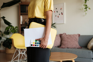 Anonymous business woman holding documents