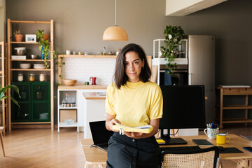 Business woman looking at camera at workplace