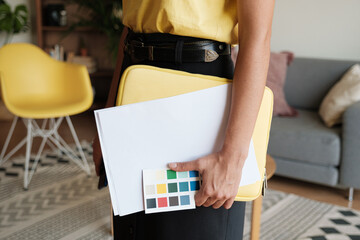 Anonymous woman holding folder and documents