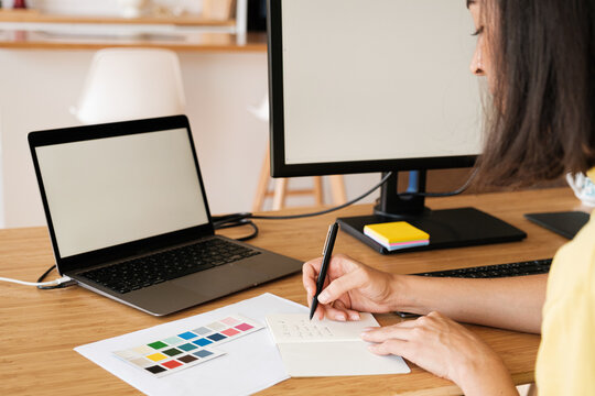 Anonymous woman using laptop and monitor