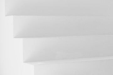Close up of geometric modern white stairs with shadows
