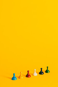 Colorful Board Game pieces on a vibrant yellow background