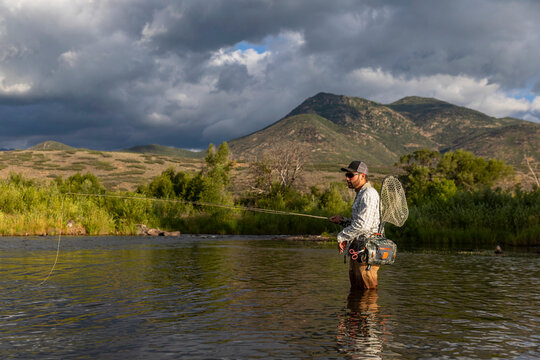 Handsome man Fly Fishing Provo River Utah in United States 