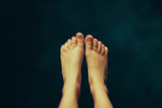 Blurry image of woman's feet in the air