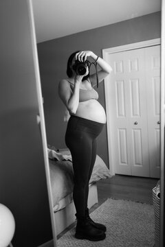 Black and white selfie of pregnant woman in third trimester