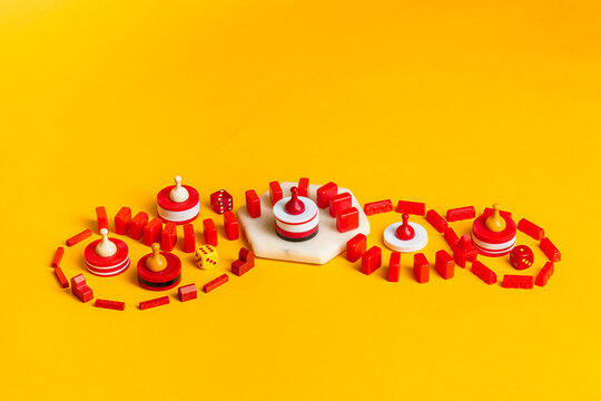 Red and yellow Board Game pieces and dice swirling
