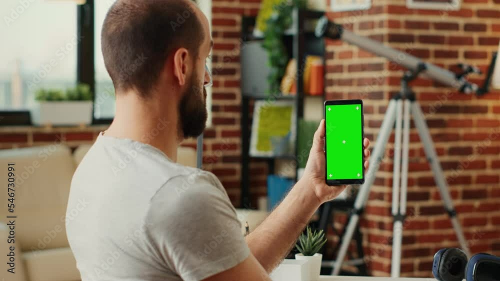 Poster office worker analyzing smartphone with greenscreen template, using isolated display with chroma key