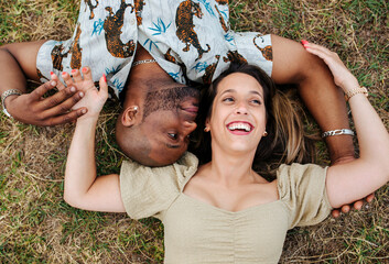 Happy couple lying on grass
