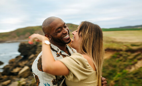 Happy couple hugging in countryside