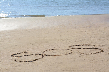 SOS message written on sand near sea