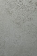Texture of light grey stone surface as background, closeup
