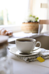 Fototapeta na wymiar Tea bag in cup on white wooden table indoors