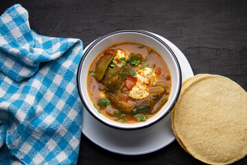 Mexican food. Tradicional rajas with cheese in red sauce.