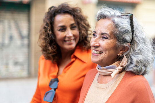 Senior women laughing together in the street