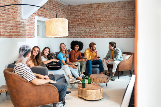 Friends having fun on the sofa at home