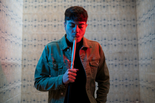 Man smoking hookah in small room