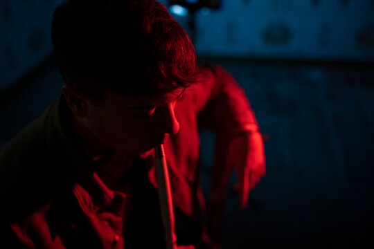 Man with hookah pipe at night