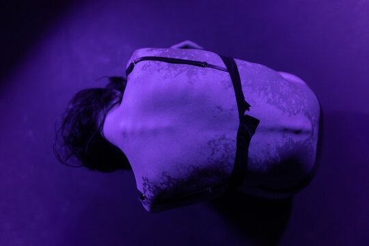 Portrait with ultra violet lighting of woman with spotted skin