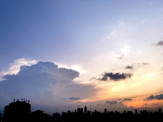 sunset over the city with building silhouette