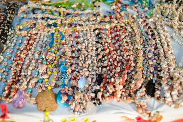 Handmade necklaces made of snails shells. Sale of accessories in a Mexican market.
