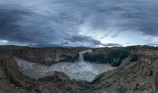 View of Aldeyjarfoss Waterfall with a cloudy sky at sunset, Iceland