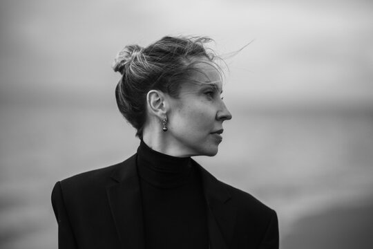 bw portrait of a beautiful woman on the empty beach in autumn