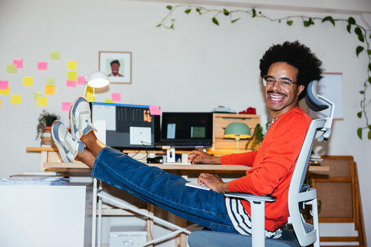 Merry mixed race man working remotely from home