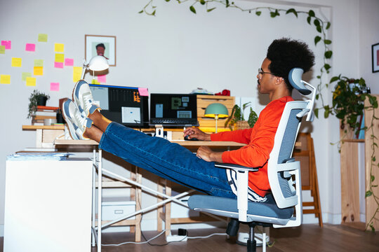 Mixed race freelancer browsing data on computer