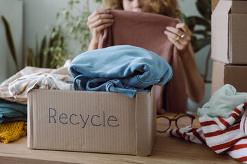 Old clothes in a cardboard box before being sent for recycling