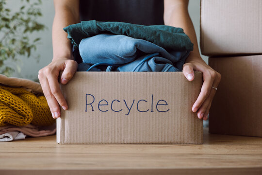 Old clothes in a cardboard box before being sent for recycling