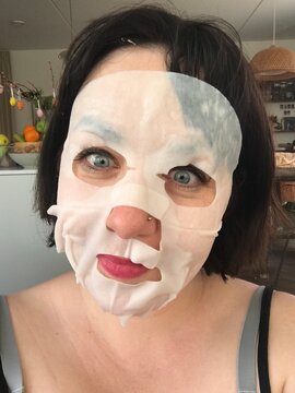 funny portrait of mother with beauty mask on her face