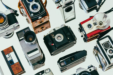 Collection of vintage film cameras arranged on a mirror diagonally 