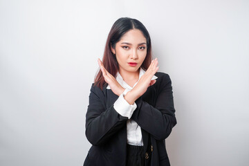 Beautiful Asian woman wearing black suit with hand gesture pose rejection or prohibition with copy...