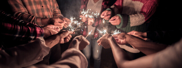 Fireworks burning sparkler in human hands in new year party night