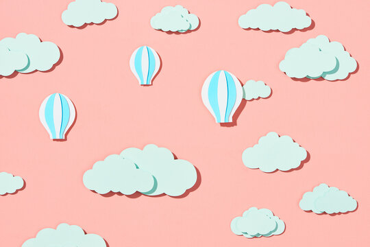 Hot air balloon flying on the sky with cloud. Paper art style